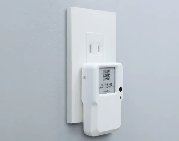 obniz BLE/Wi-Fi Gateway plugged into a wall outlet